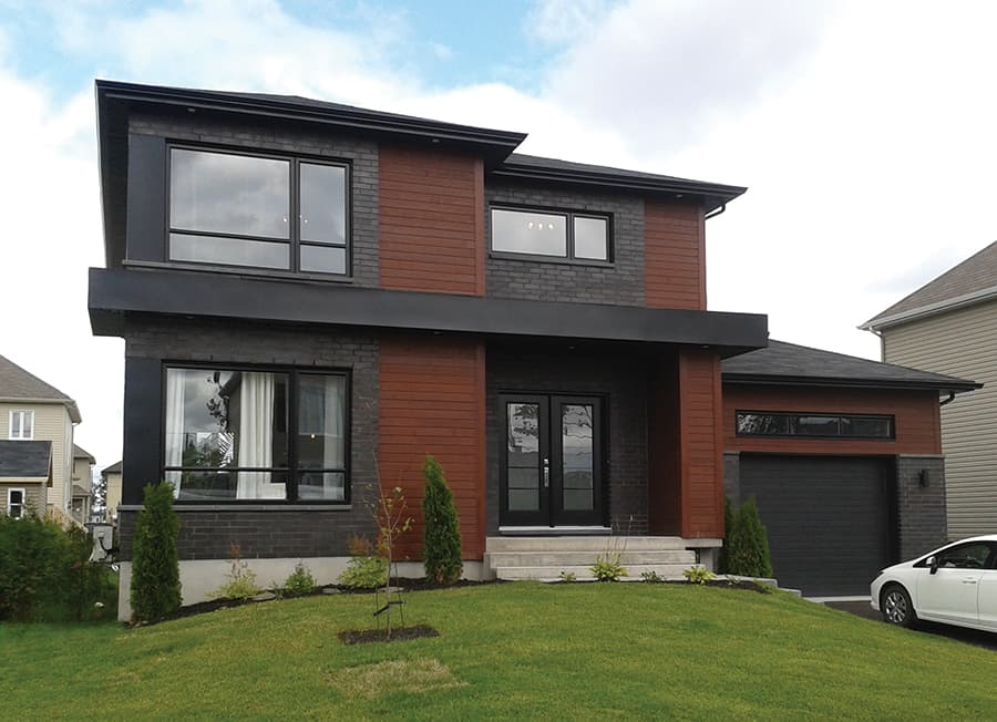 Modern two-story house plan exterior with stone brick, wood siding, large windows, and attached garage.