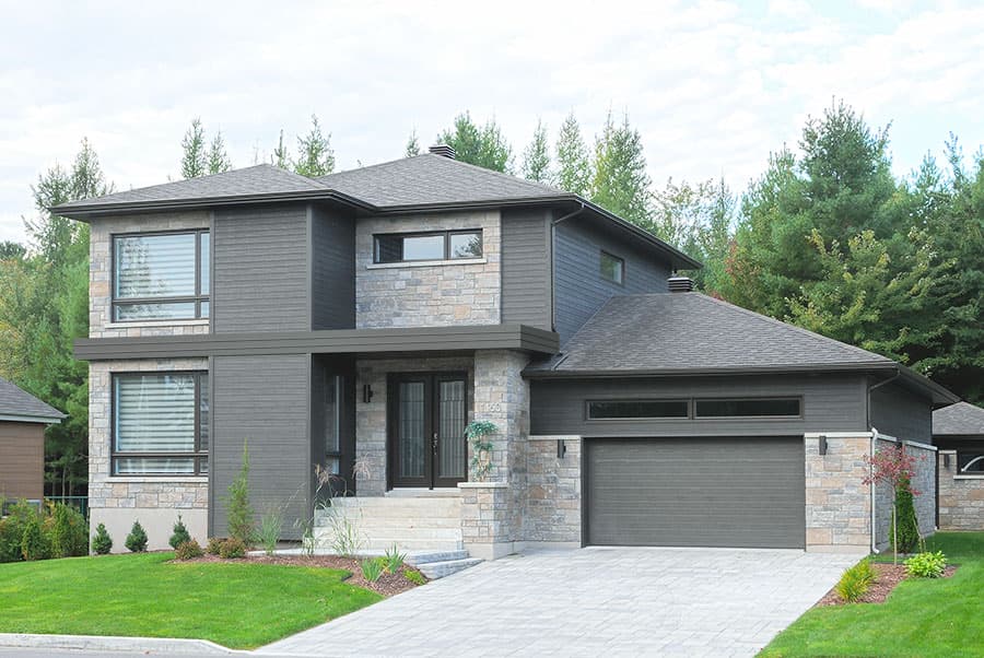 Modern house plan exterior with stone and wood siding, two stories, prominent gables, and attached garage.