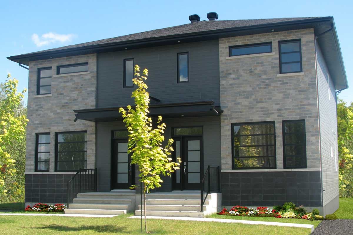 Two-story modern house plan exterior with stone and dark siding, multiple windows, and dual front entrances.