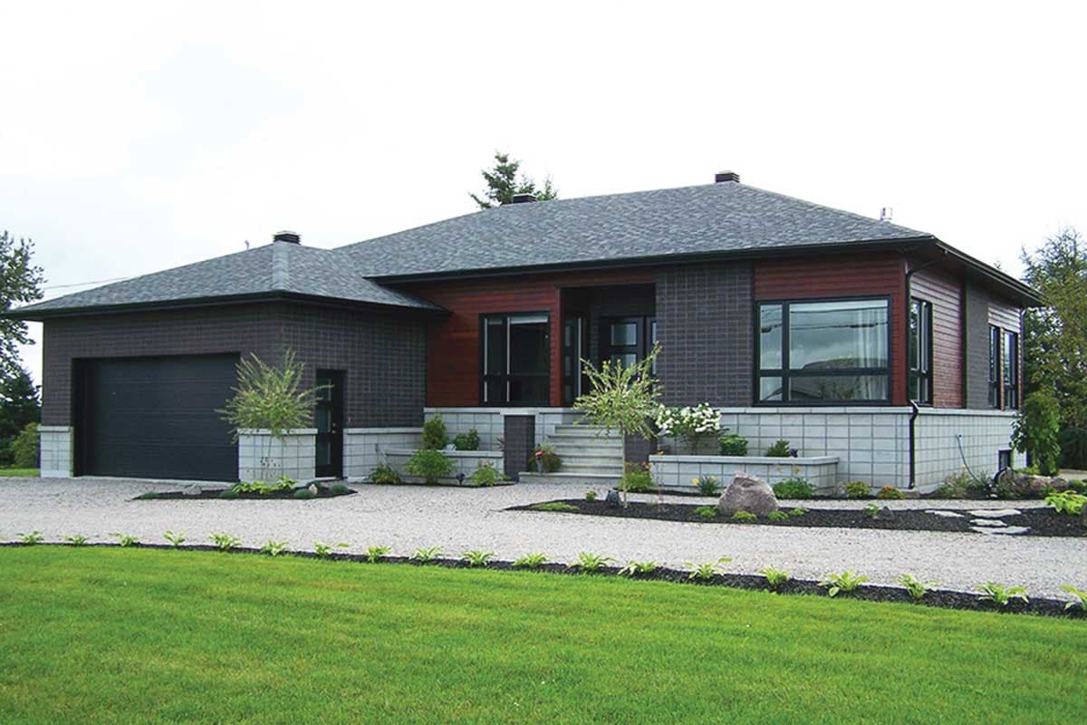 Modern house plan exterior with dark brick, wood siding, attached garage, and tiered landscaping.