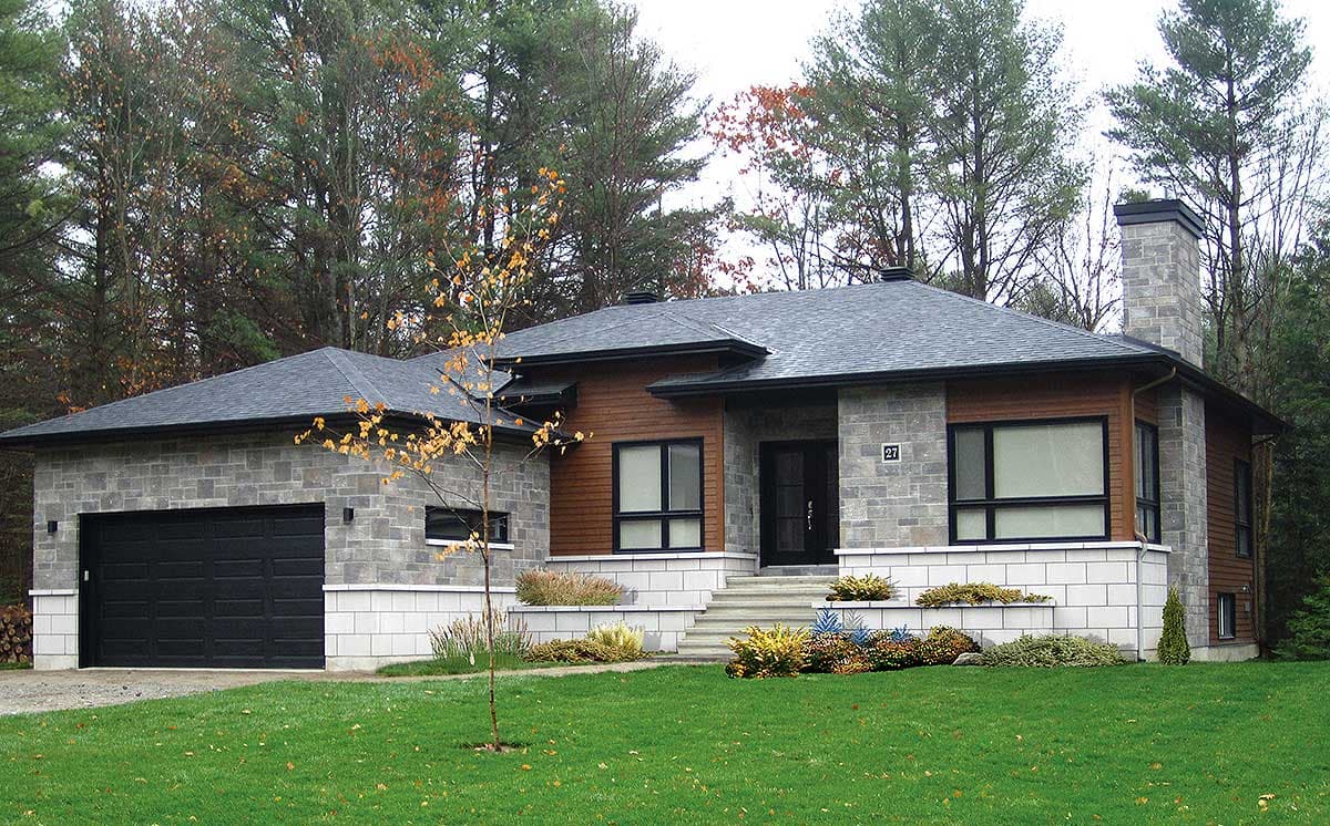 House plan exterior: Single-story modern home with stone and wood siding, attached garage, and large windows.