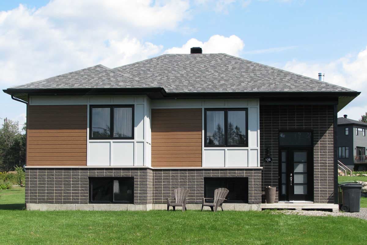 House plan exterior with modern architectural style, brick base, wood siding, and multiple gables.