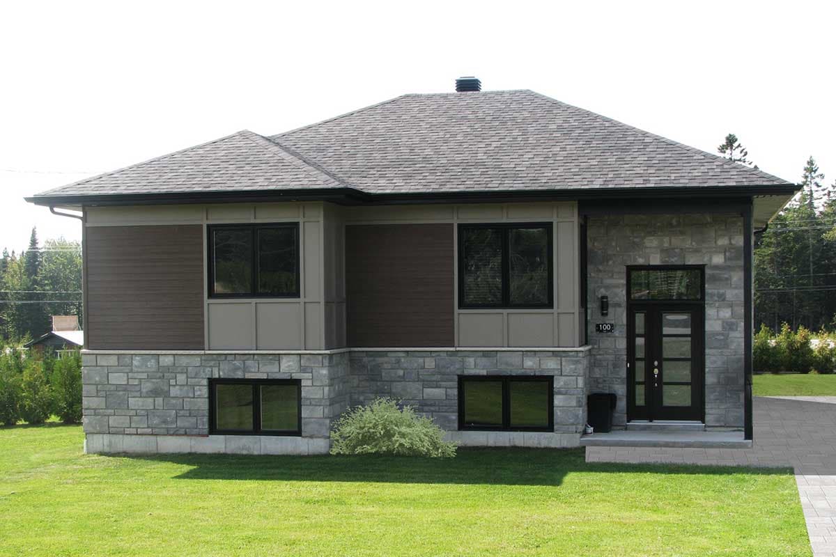 House plan exterior: Modern two-story home with stone and wood siding, multiple gables, and a double-door entrance.