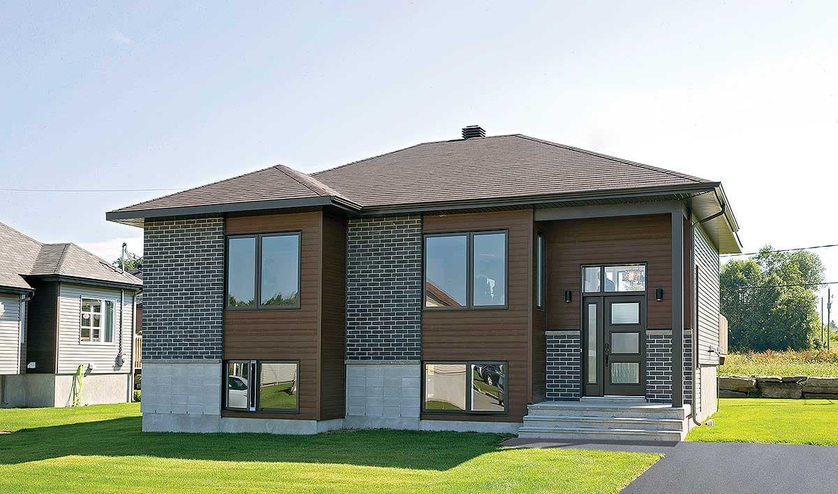 House plan exterior features dark brick, wood siding, concrete foundation, and large windows.