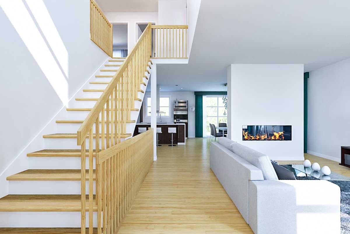 Interior view of a modern house plan showing a staircase, kitchen with island, dining area, and living room with fireplace.