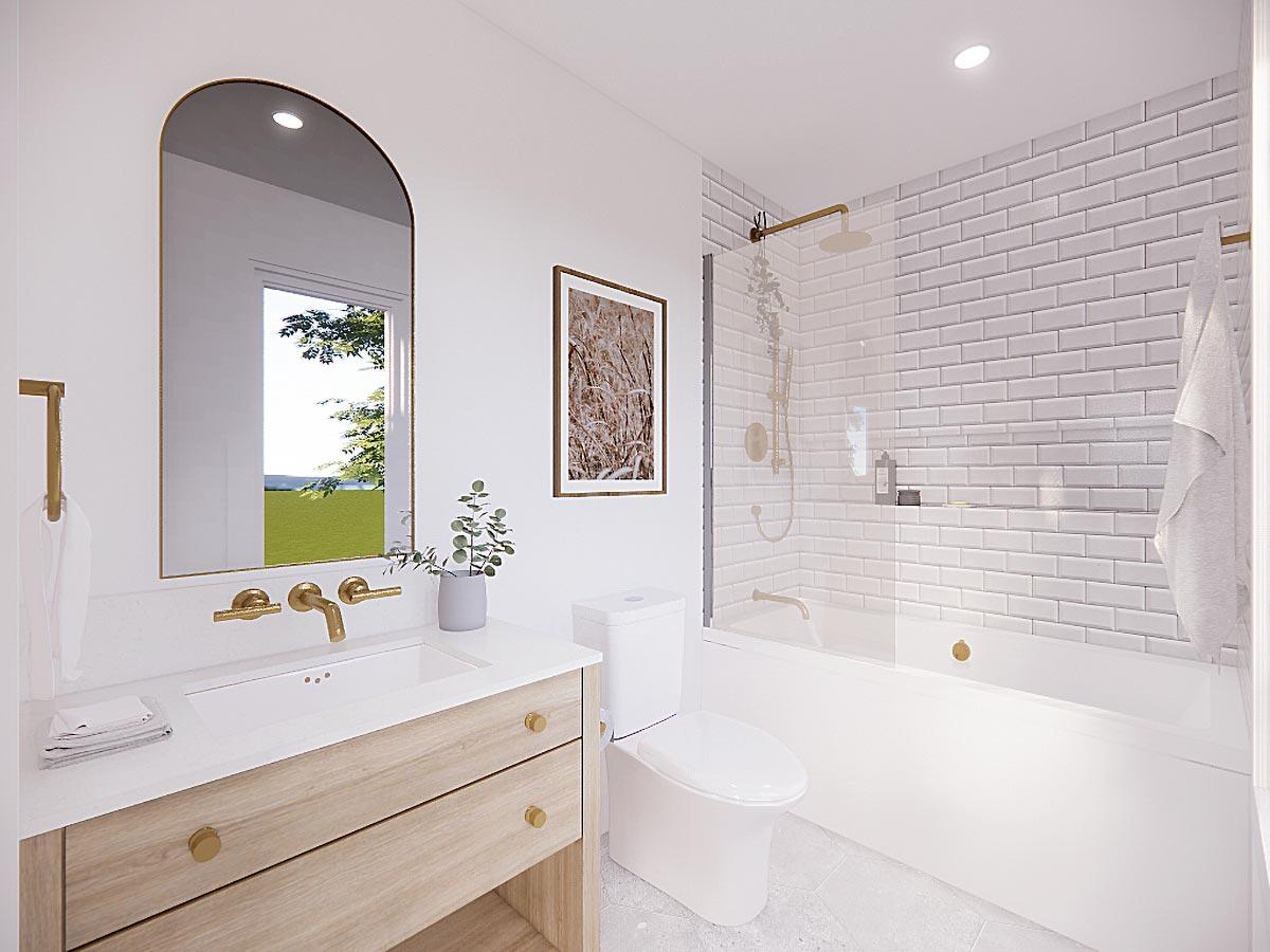 Modern bathroom with arched mirror, wood vanity, subway tile shower, and bathtub.