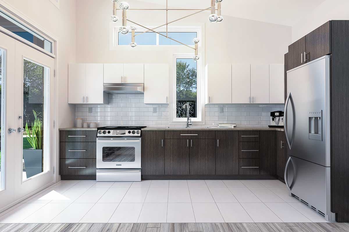 Modern kitchen with white and dark wood cabinetry. Stainless steel appliances, including a range and refrigerator, complement the design. Large window provides natural light.