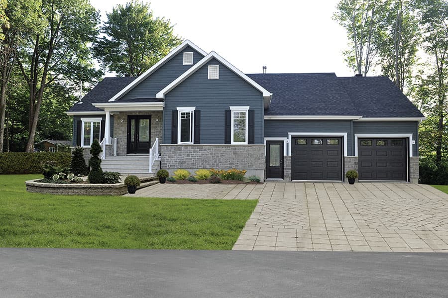 House plan exterior: Ranch style, one story, dark siding, stone base, double garage, front entrance with steps and black doors.