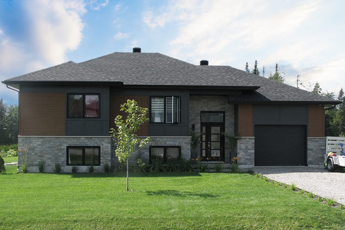 Modern house plan exterior with stone and wood siding, dark garage door, large windows, and a covered entry.