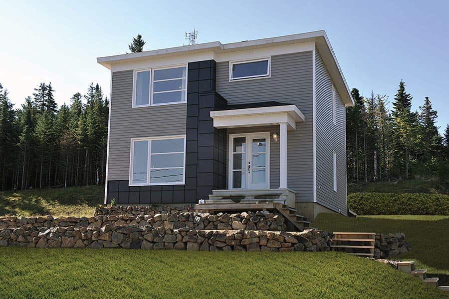 House plan exterior: Two-story home with horizontal siding, a covered front porch, and large windows.