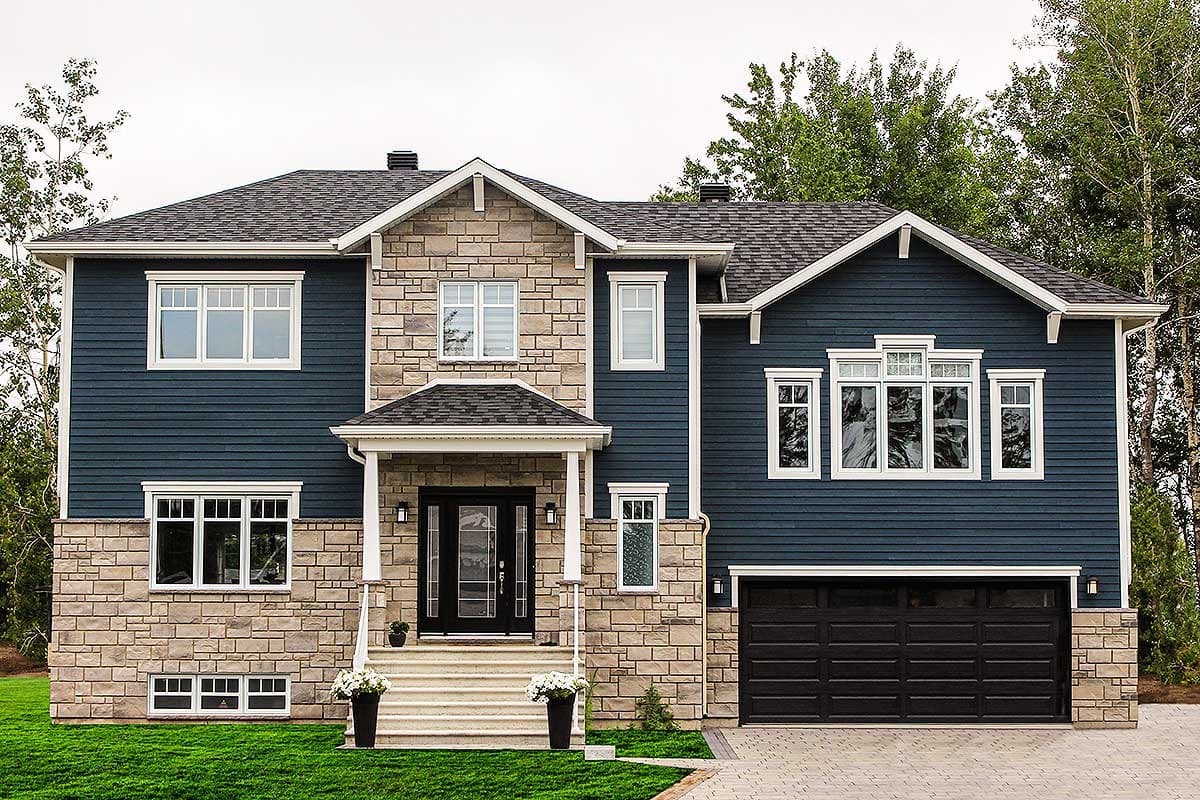 House plan exterior. Two-story home with stone and blue siding, front porch, multiple gables, and attached garage.