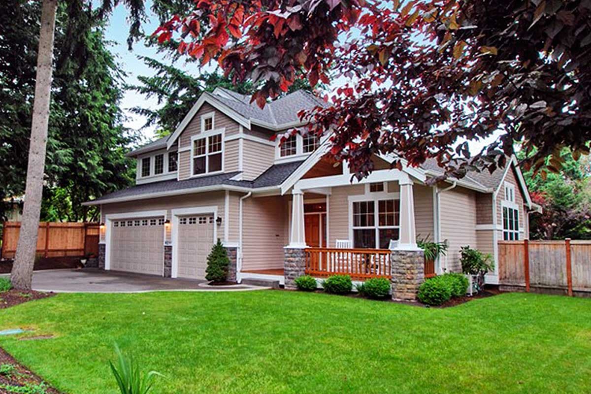House plan exterior view of a two-story home with Craftsman style. Features include a front porch, multiple gables, and an attached garage.
