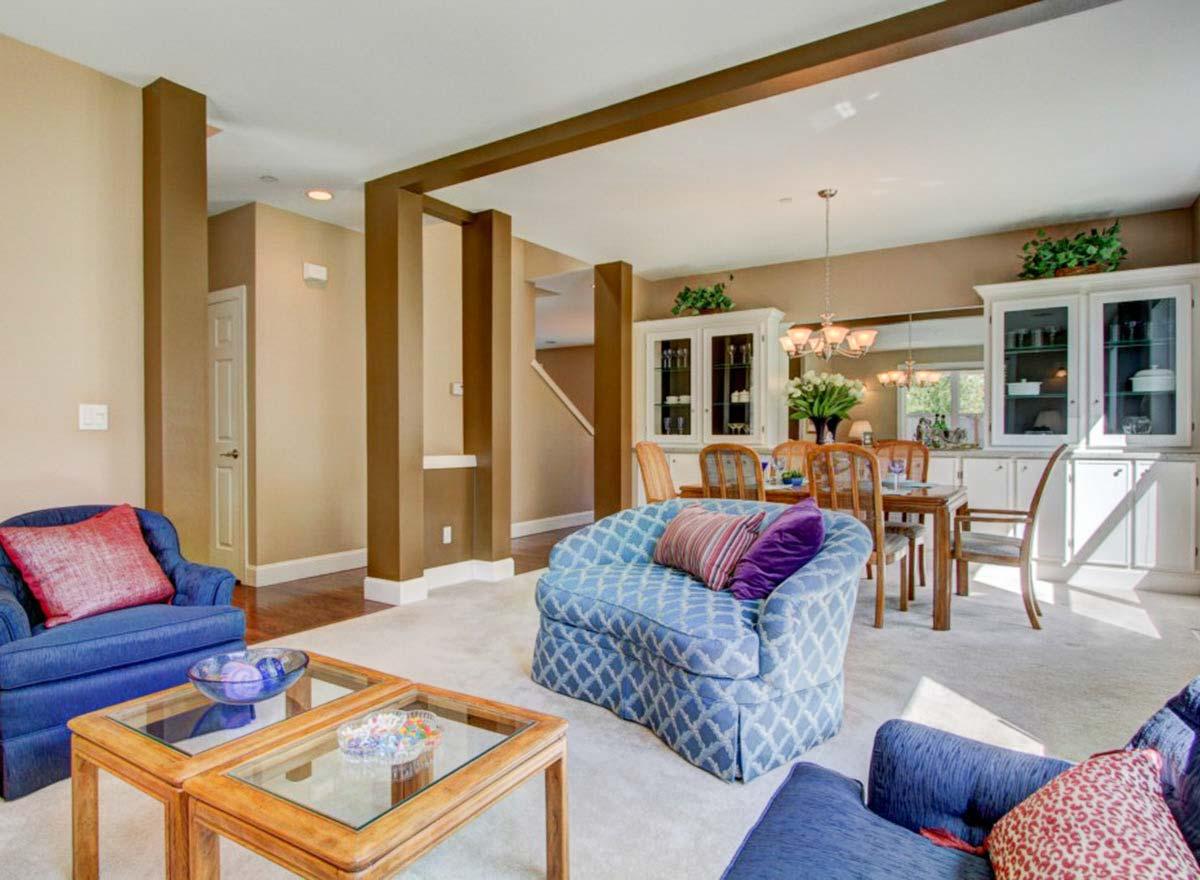 Living and dining area with built-in cabinets, dining table, and upholstered seating.