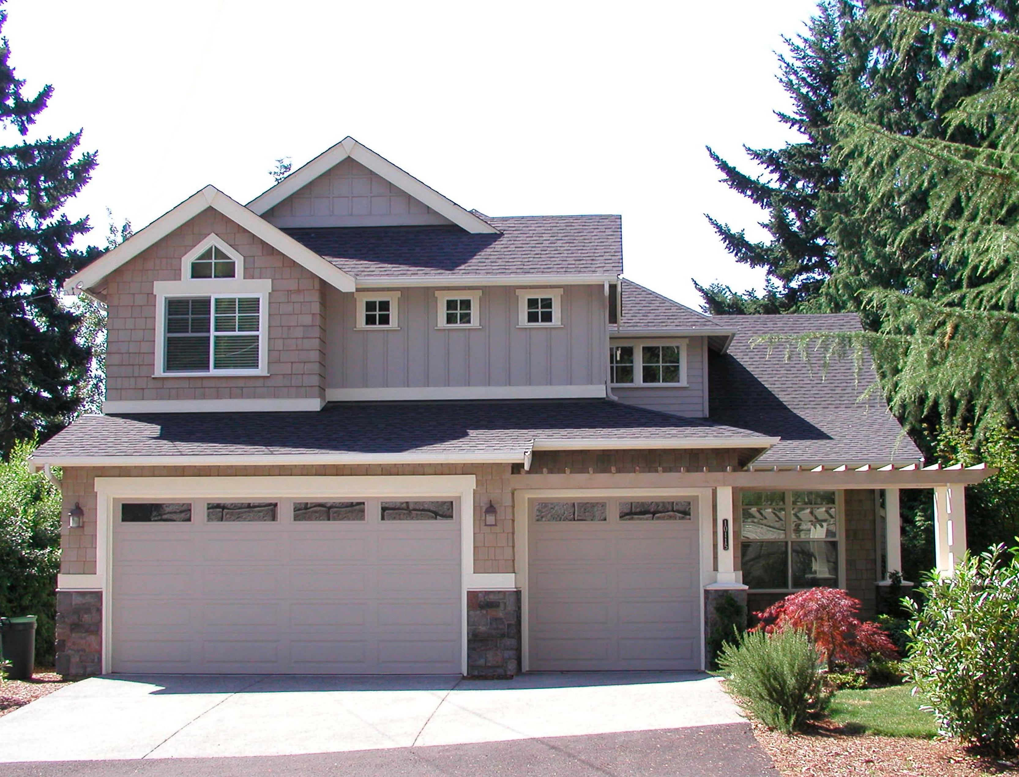 House plan exterior with two-car garage, gables, and shingle siding.