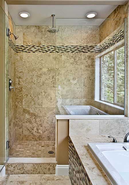 Master bathroom with tiled shower, soaking tub, and double vanity. Features travertine tile and glass enclosure.