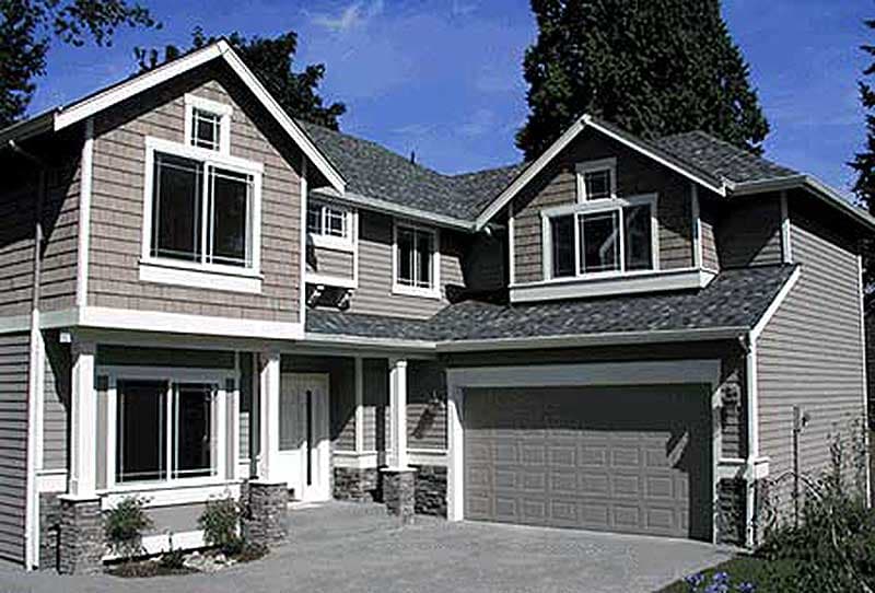 House plan exterior: two-story home with gables, dormers, shingle siding, and a front-facing garage.