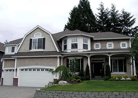 House plan exterior featuring a gambrel dormer, multi-story structure, bay window, and covered front porch with columns.