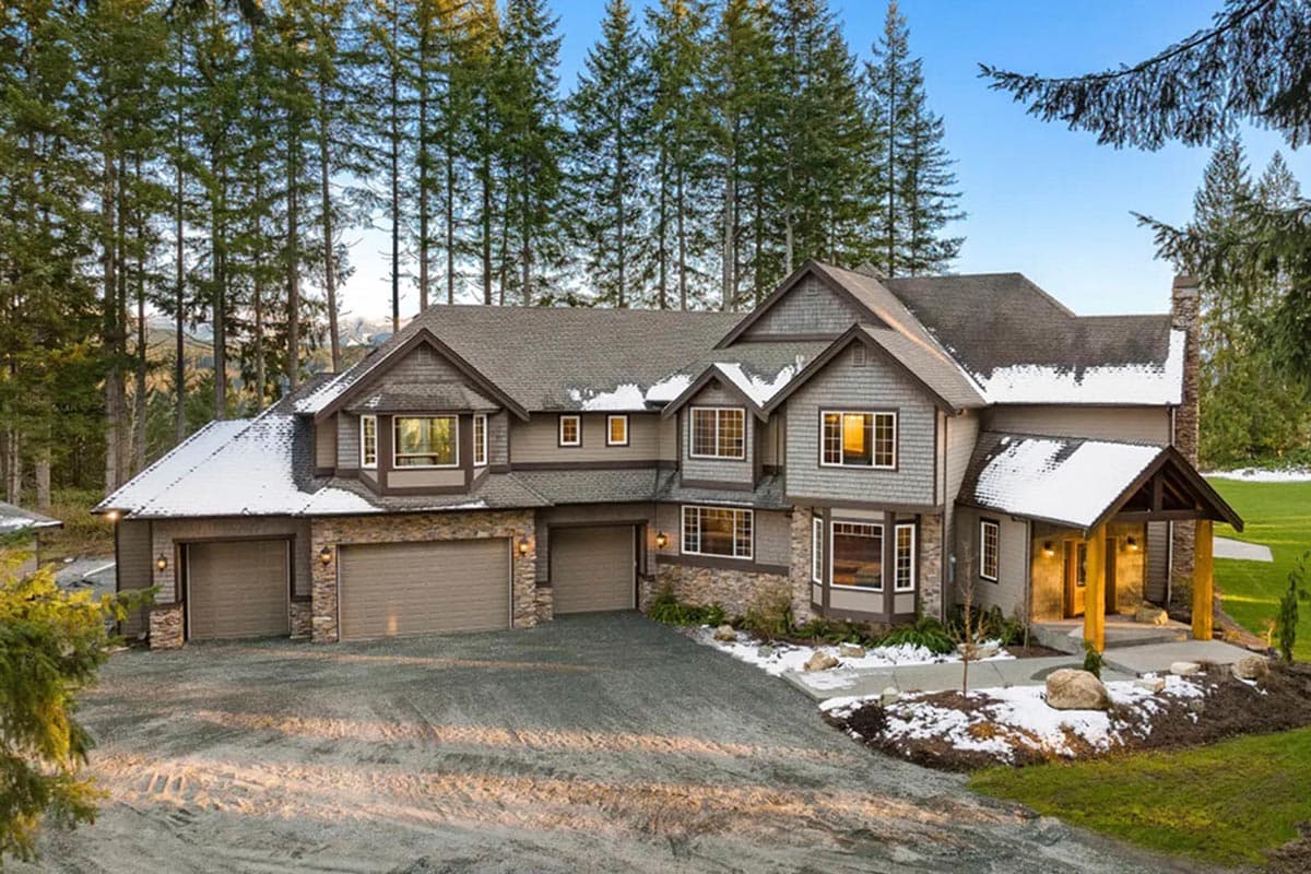 House plan exterior with Craftsman style, two stories, front-facing garage, gables, and a covered entry porch.