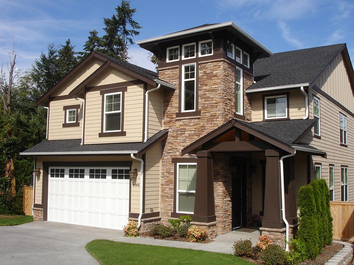 House plan exterior: Two-story Modern Craftsman with stone accents, covered entry porch with pillars, and a side-entry garage.