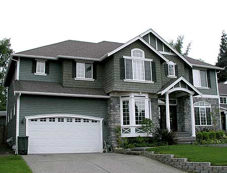 Two-story house plan exterior with stone accents, arched windows, dormers, and a two-car garage.