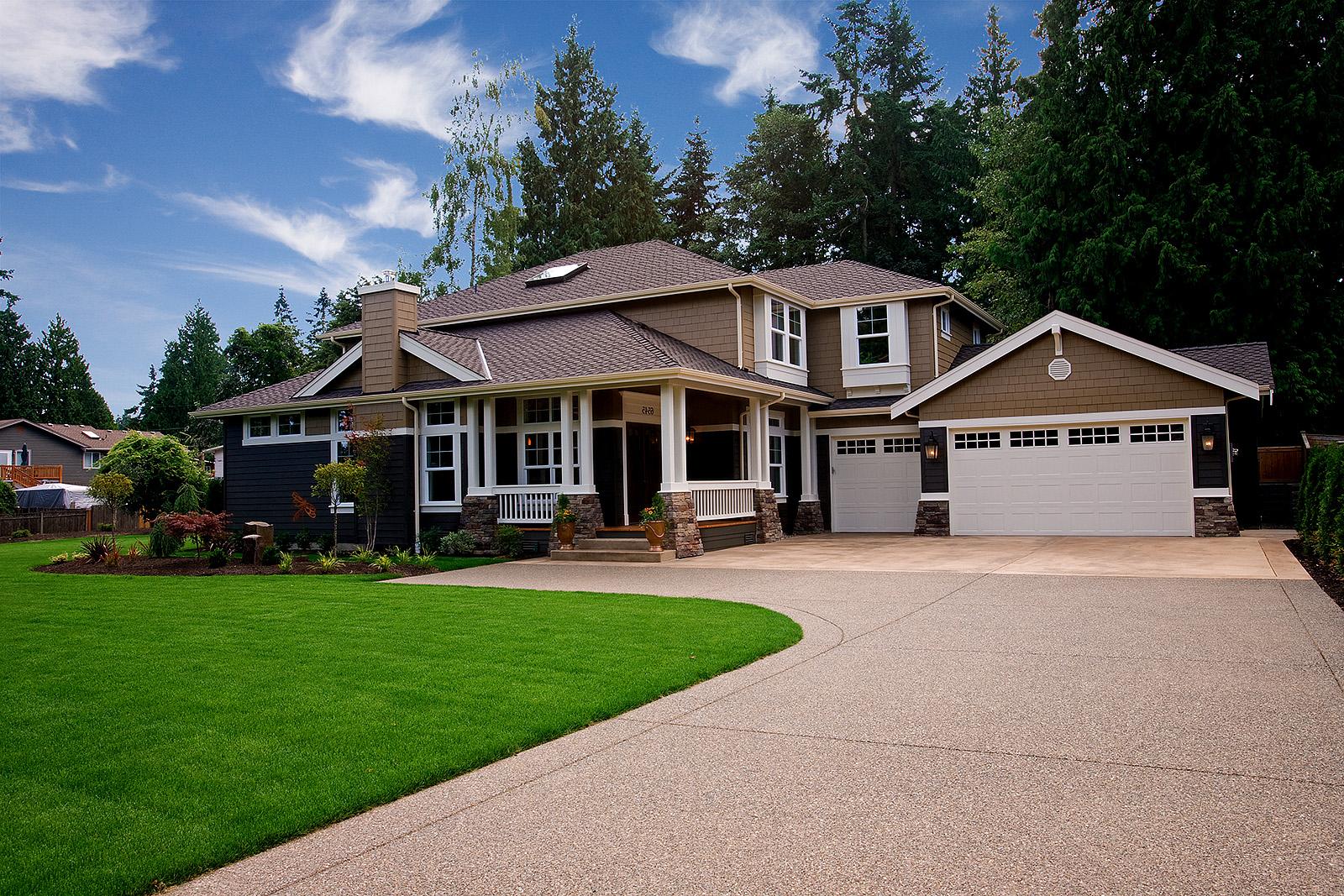 House plan exterior: Two-story home with covered front porch, gabled dormers, stone accents, and a three-car garage.