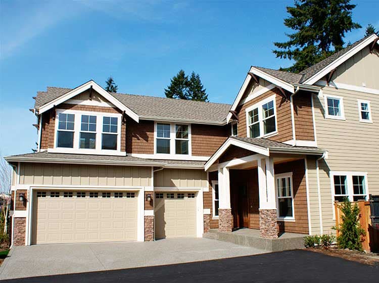 Craftsman style two-story house plan exterior with wide eaves, gabled dormers, stone-accented porch, and a three-car garage.