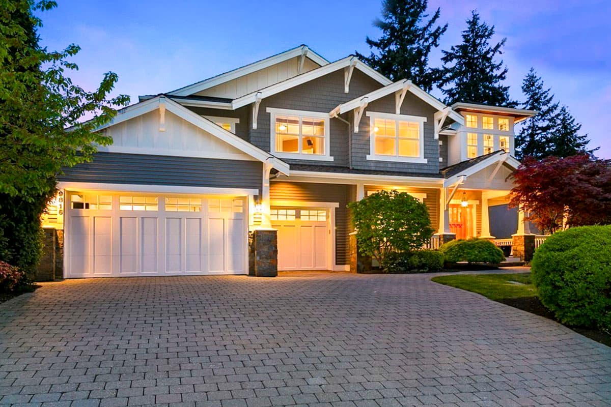 House plan exterior featuring a two-story Craftsman style home with a gabled roofline, dormers, and a covered porch. Garage faces front.