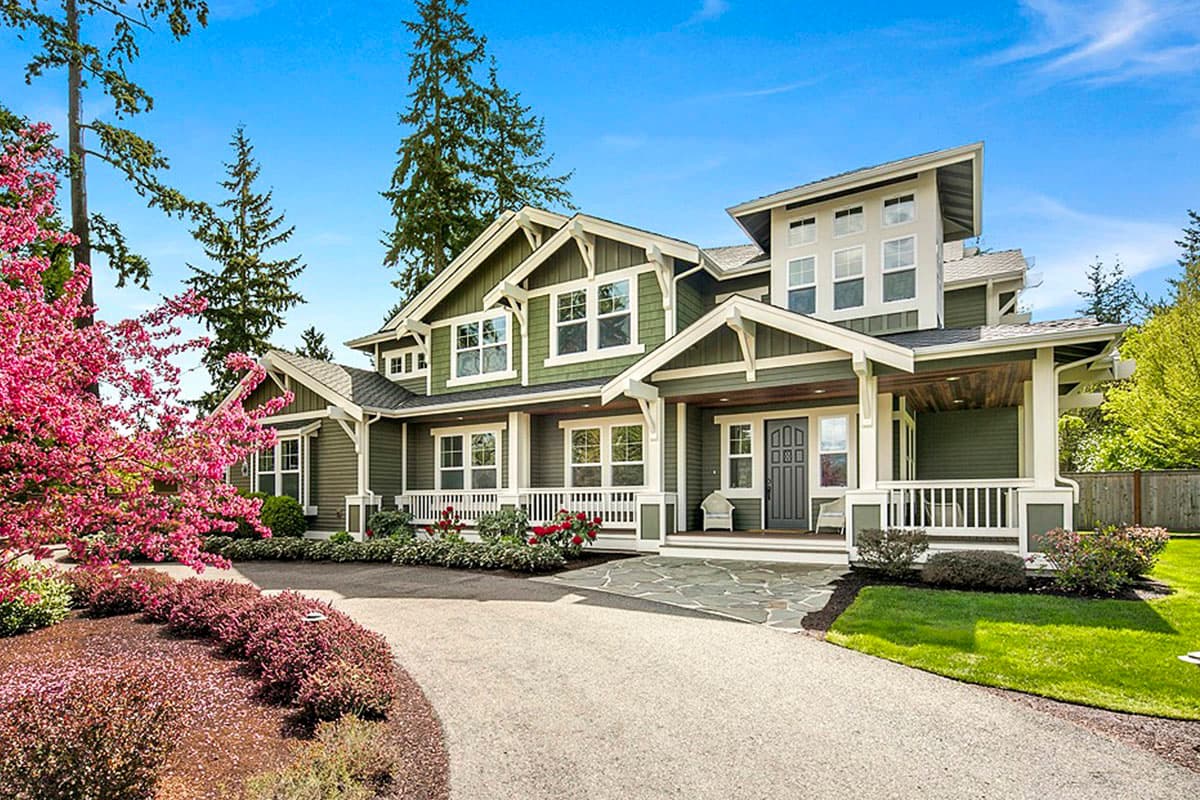 Modern Craftsman house plan exterior with a prominent covered entry porch, multiple gables, and dormer windows.