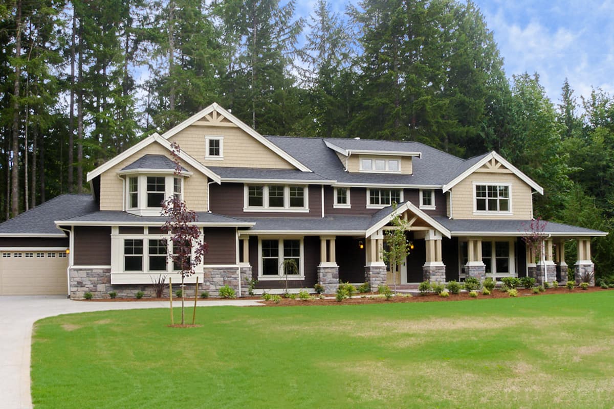 House plan exterior: Two-story modern farmhouse with gables, dormers, large windows, and a covered front porch.
