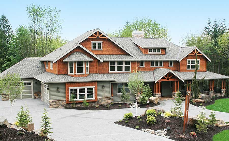 Craftsman style house plan exterior with two-car garage, covered entry porch, and multiple gables.