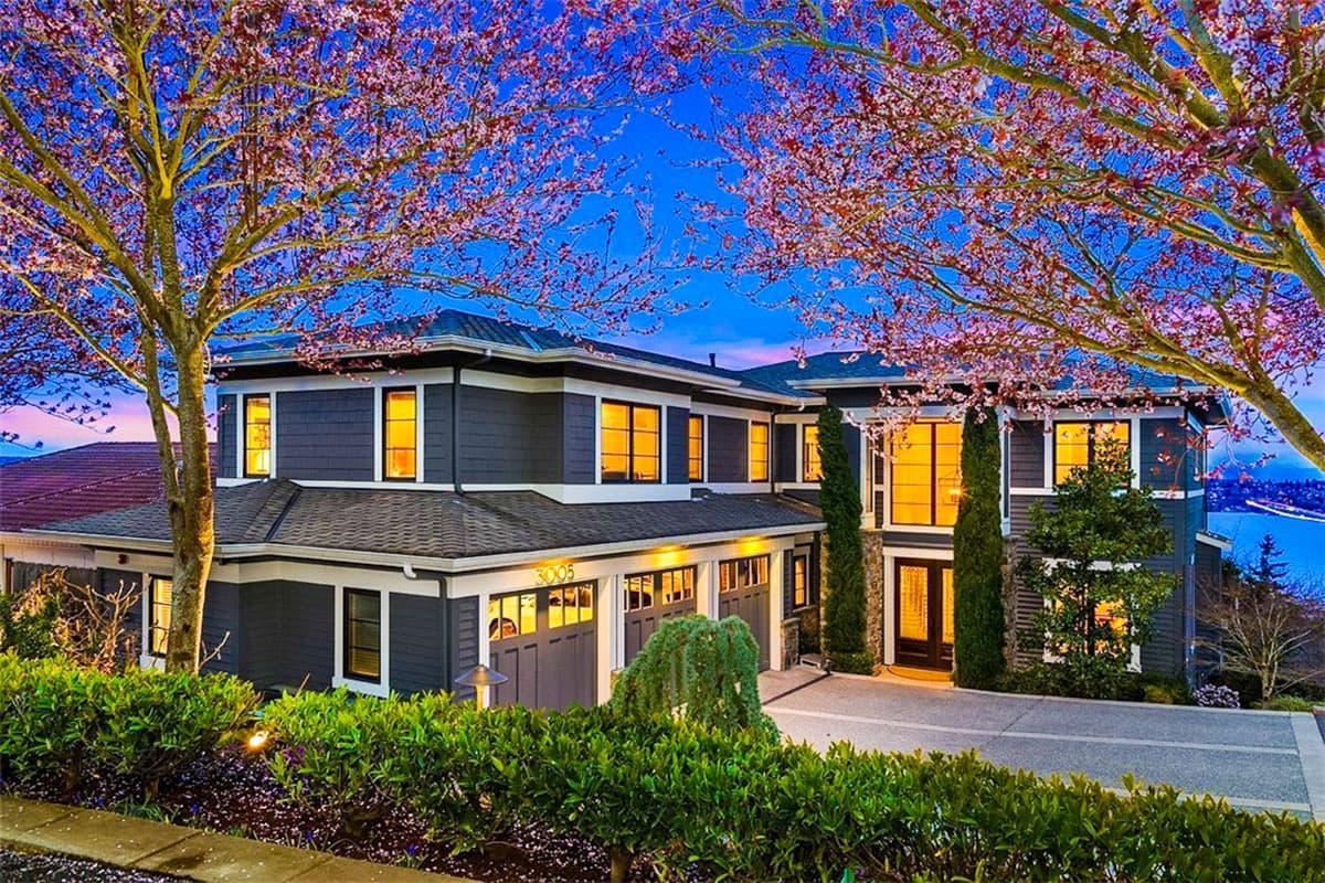 House plan exterior of a two-story Modern home with a multi-car garage, prominent gables, and large windows.