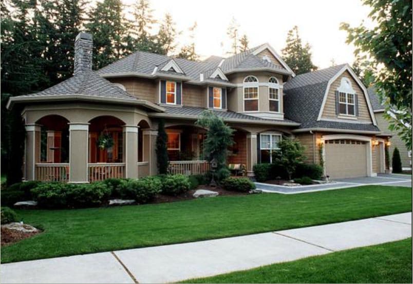 House plan exterior: Two-story home with arched entryway, prominent chimney, dormers, and attached two-car garage.