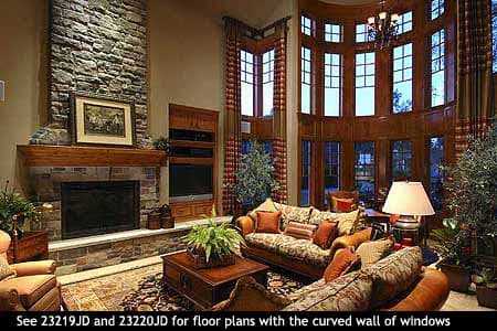 Interior rendering of a great room with a stone fireplace and a curved wall of tall windows.