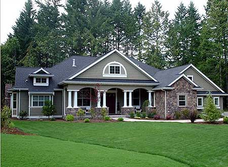 House plan exterior: One-story home with covered front porch, arched dormer, stone accents, and multi-level rooflines.
