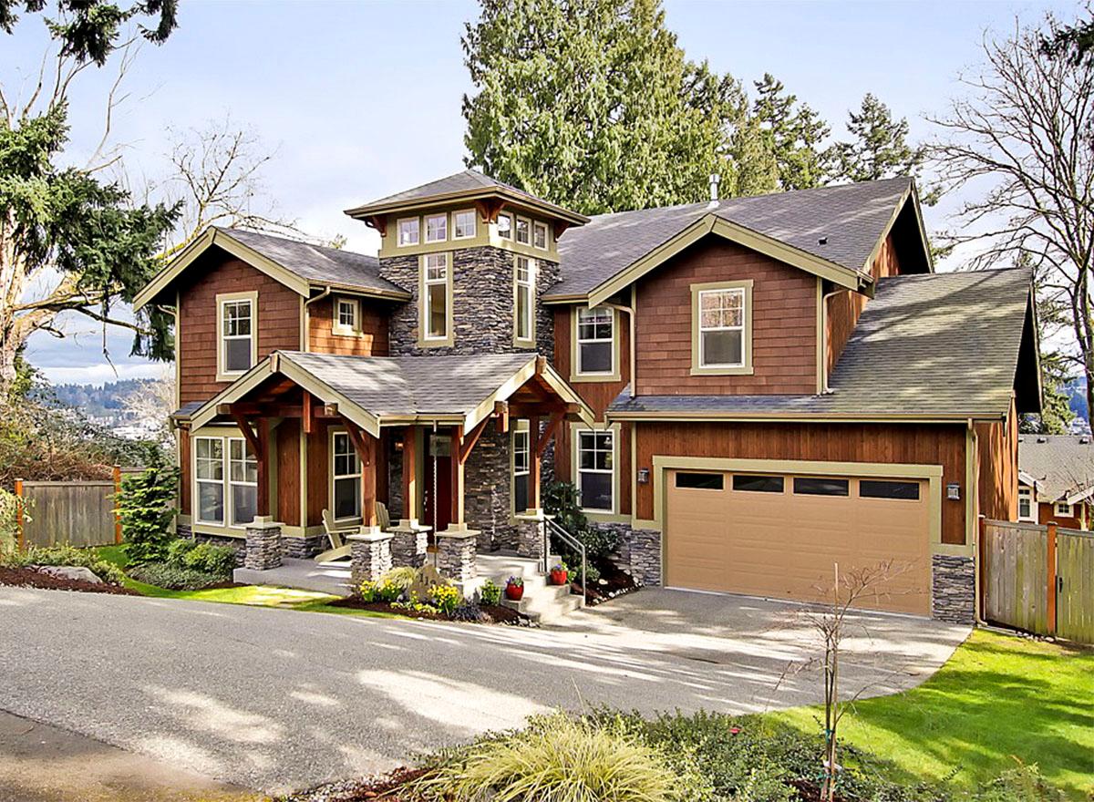 Craftsman style house plan exterior with a covered porch, stone accents, multiple gables, and a two-car garage.