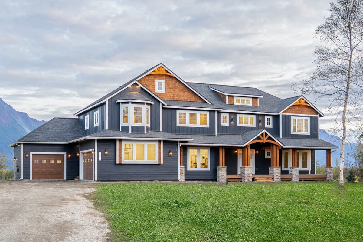 House plan exterior. Two-story home with Craftsman-style elements, front porch, multiple gables, and attached garage.