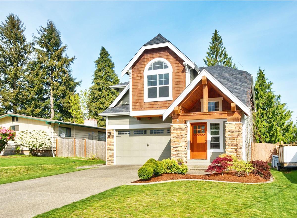 House plan exterior: Two-story Modern Farmhouse with shingle siding, stone accents, prominent gable, and covered entry with wood beams.
