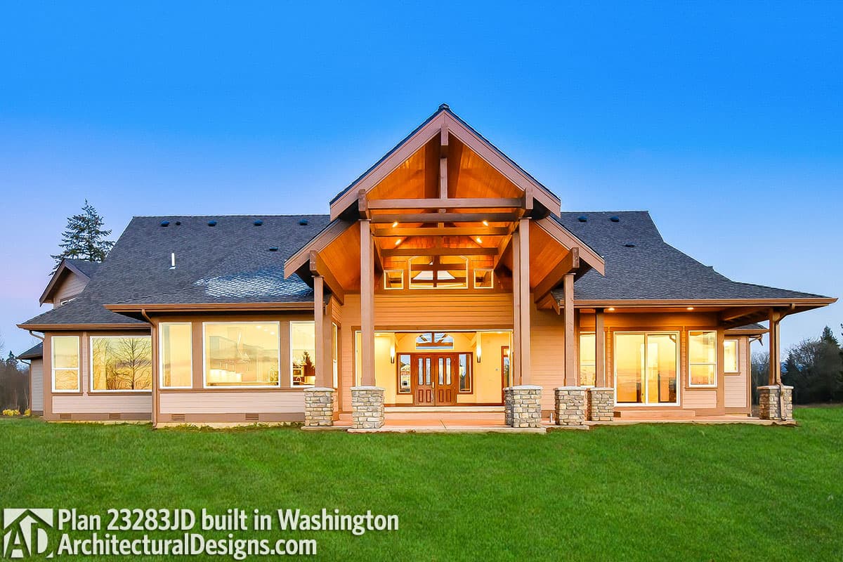 House plan exterior: Modern Farmhouse style, one story, with covered entryway, prominent gables, and expansive windows.