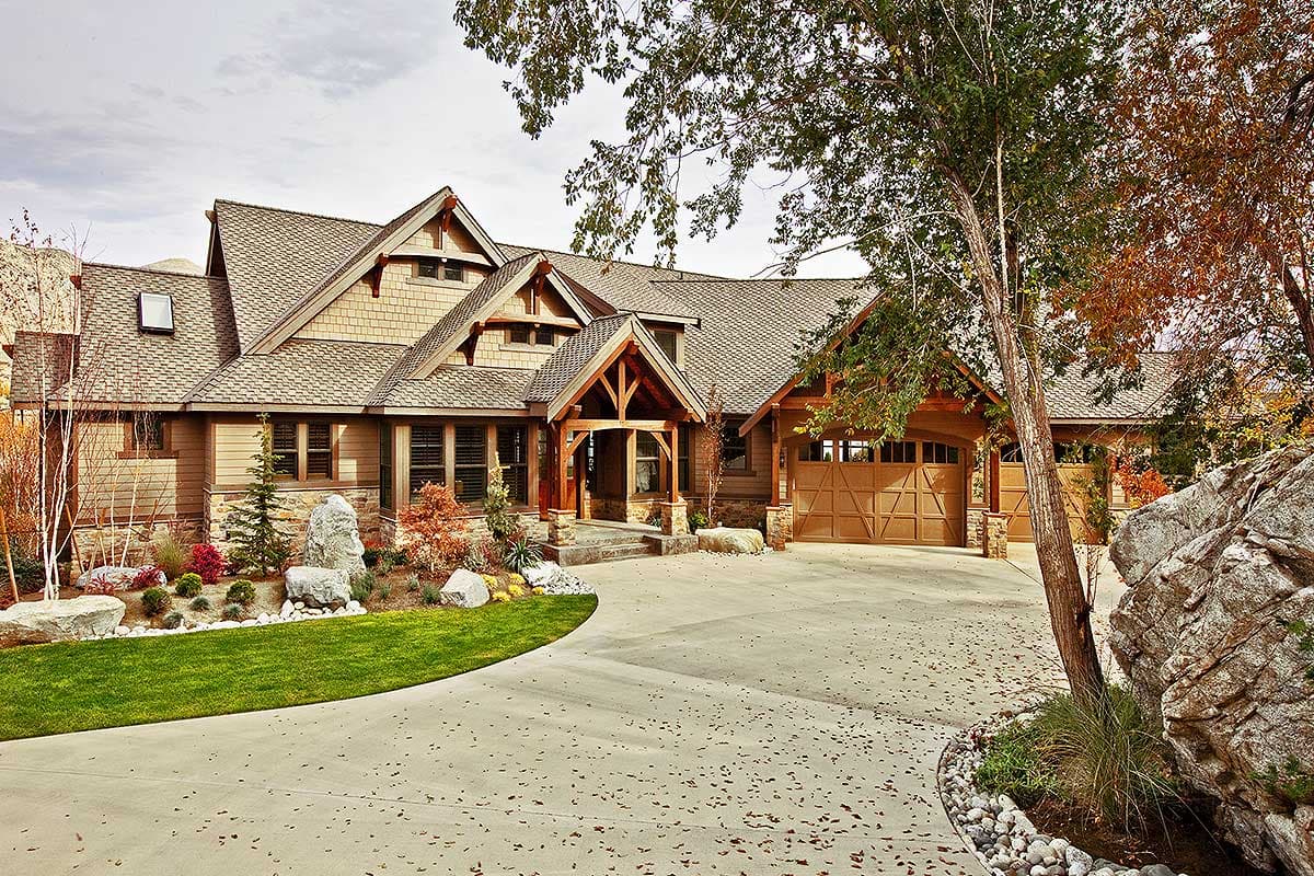 House plan exterior shows a Craftsman-style home with multiple gables, exposed rafter tails, a covered porch, and a side-facing garage.