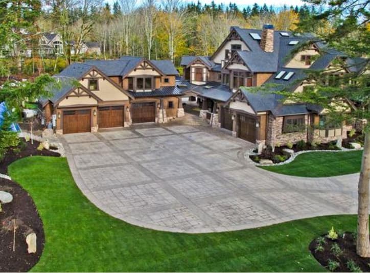 House plan exterior featuring multiple gables, dormers, stacked stone accents, and a five-car garage.