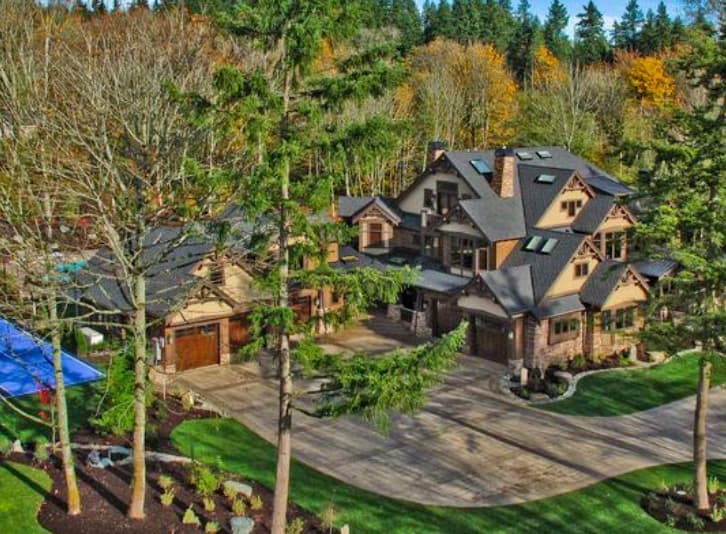 Craftsman style house plan exterior with multiple gables, stone accents, dormers, and a three-car garage.