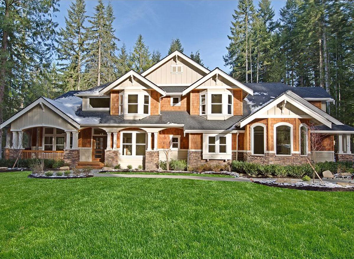 House plan exterior: Craftsman style, two stories, with covered porch, multiple bay windows, and cedar shingle siding.
