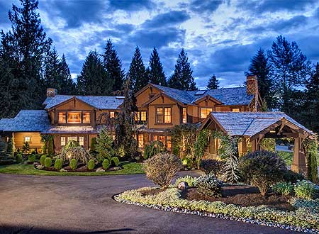 Two-story Craftsman house plan exterior with gabled dormers, stone chimney, and covered entryway.