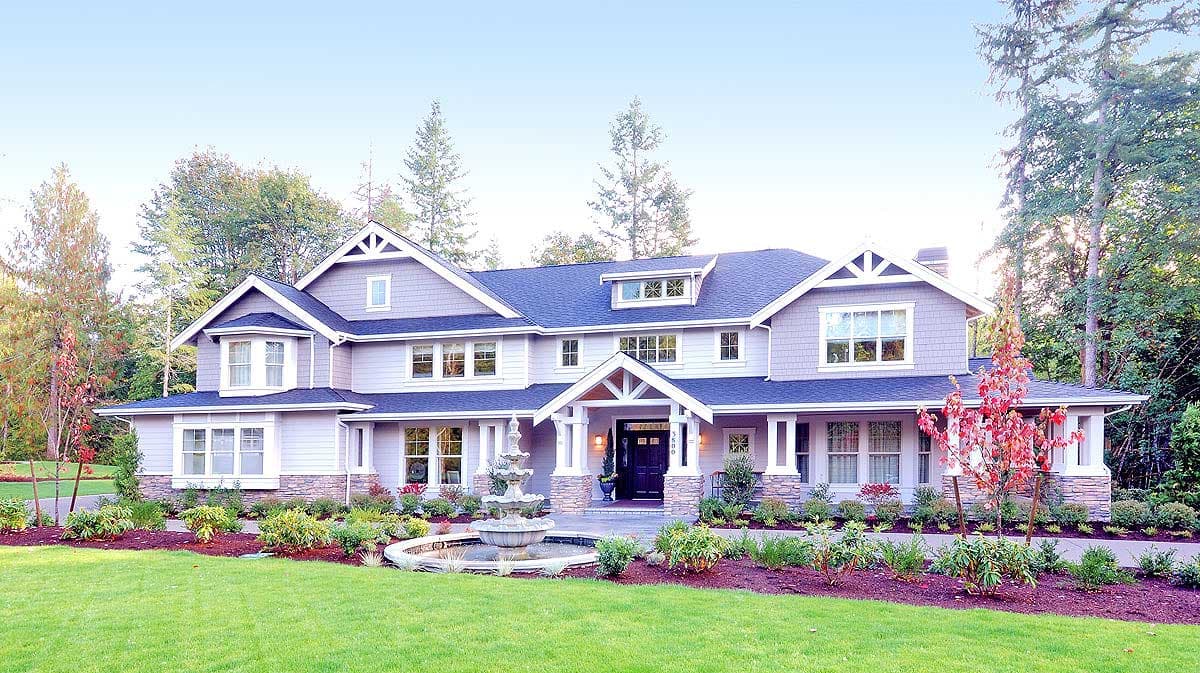 House plan exterior: Large two-story home with a covered front porch, multiple gables, dormers, and stone accents.