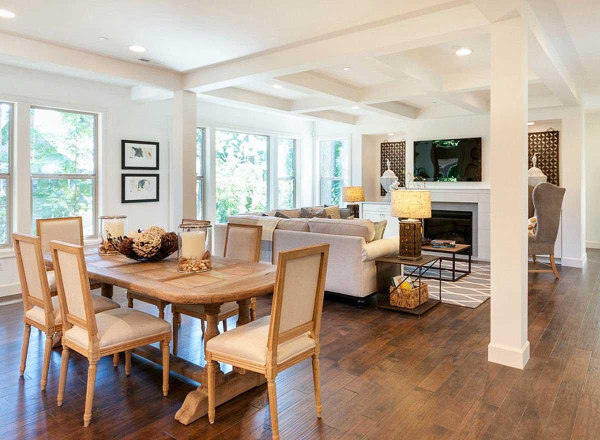 Open concept living area with dining table, sofas, fireplace, and television.