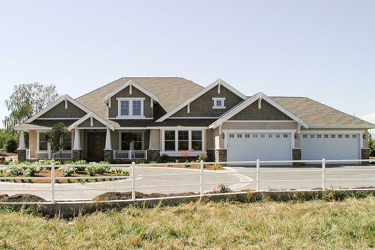 Modern Farmhouse house plan exterior with a covered front porch, multiple gables, and a four-car garage.