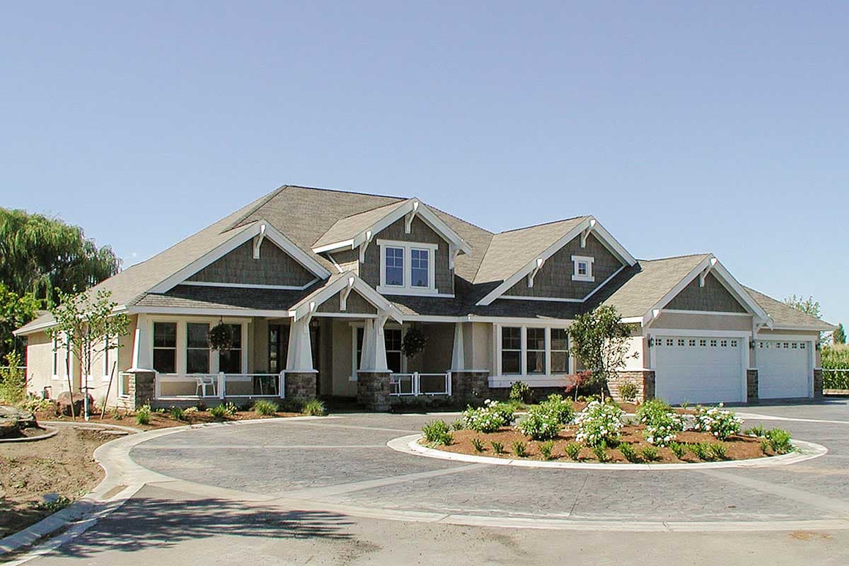 Craftsman style house plan exterior with a wraparound porch, multiple gables, dormers, and a three-car garage.