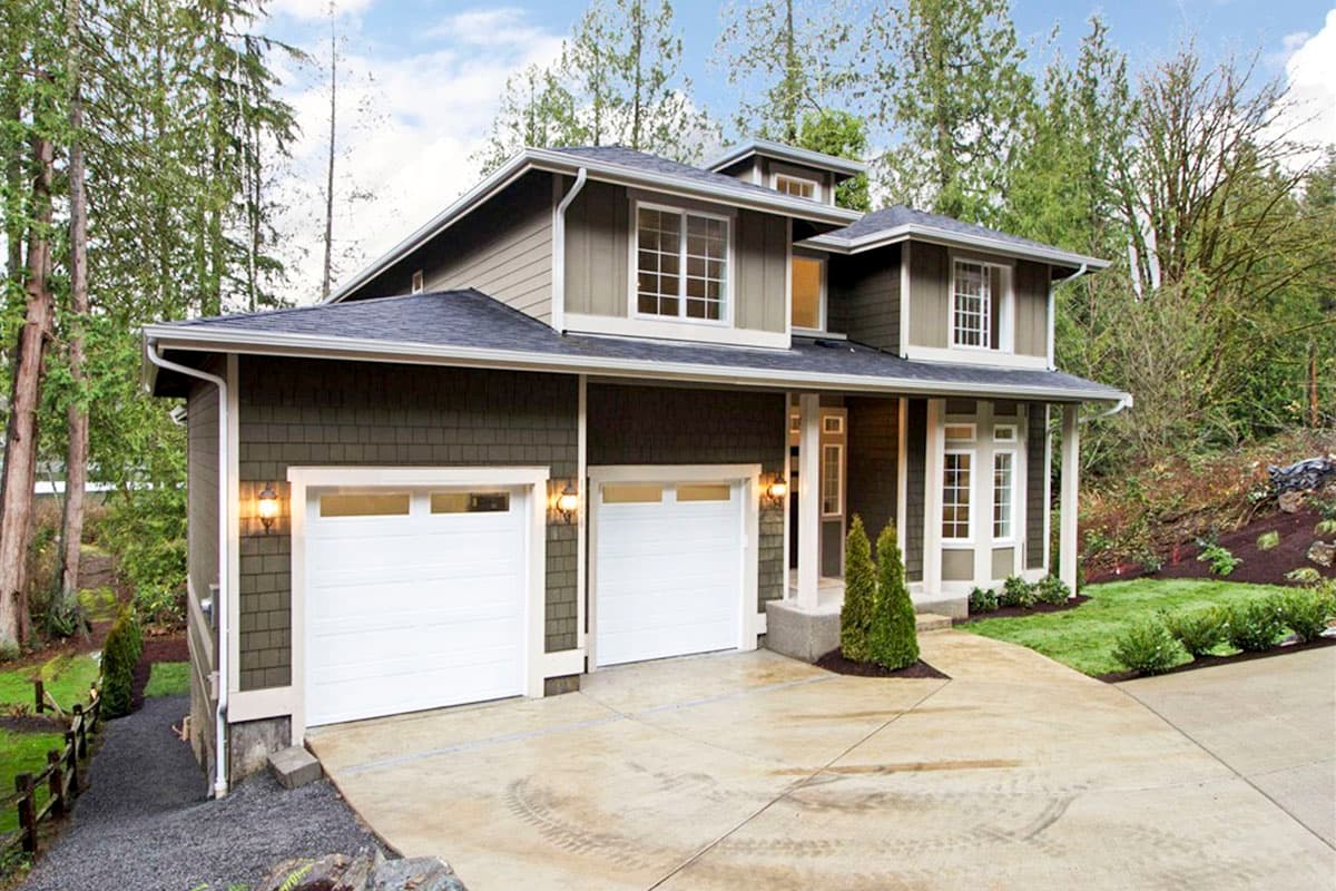 House plan exterior: Two-story home with a side-entry three-car garage, large front porch, and multiple gables.