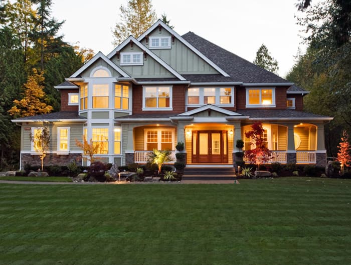 Craftsman style house plan exterior, two stories, with a wraparound porch, prominent gables, and bay windows.