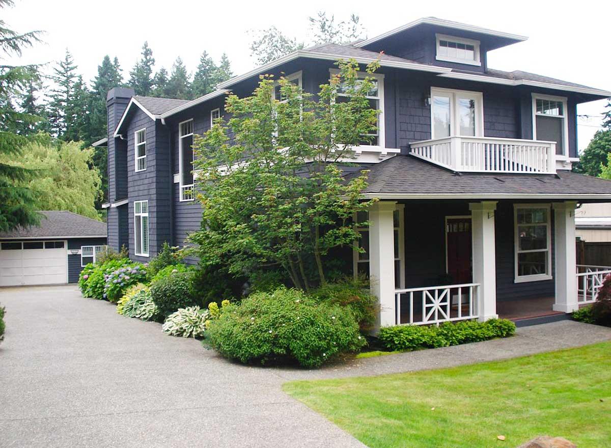 Two-story Craftsman house plan exterior with dormer, prominent porch, balcony, and attached garage.